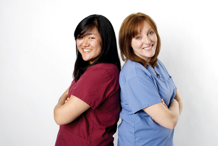 Two medical professionals smiling at the camera.