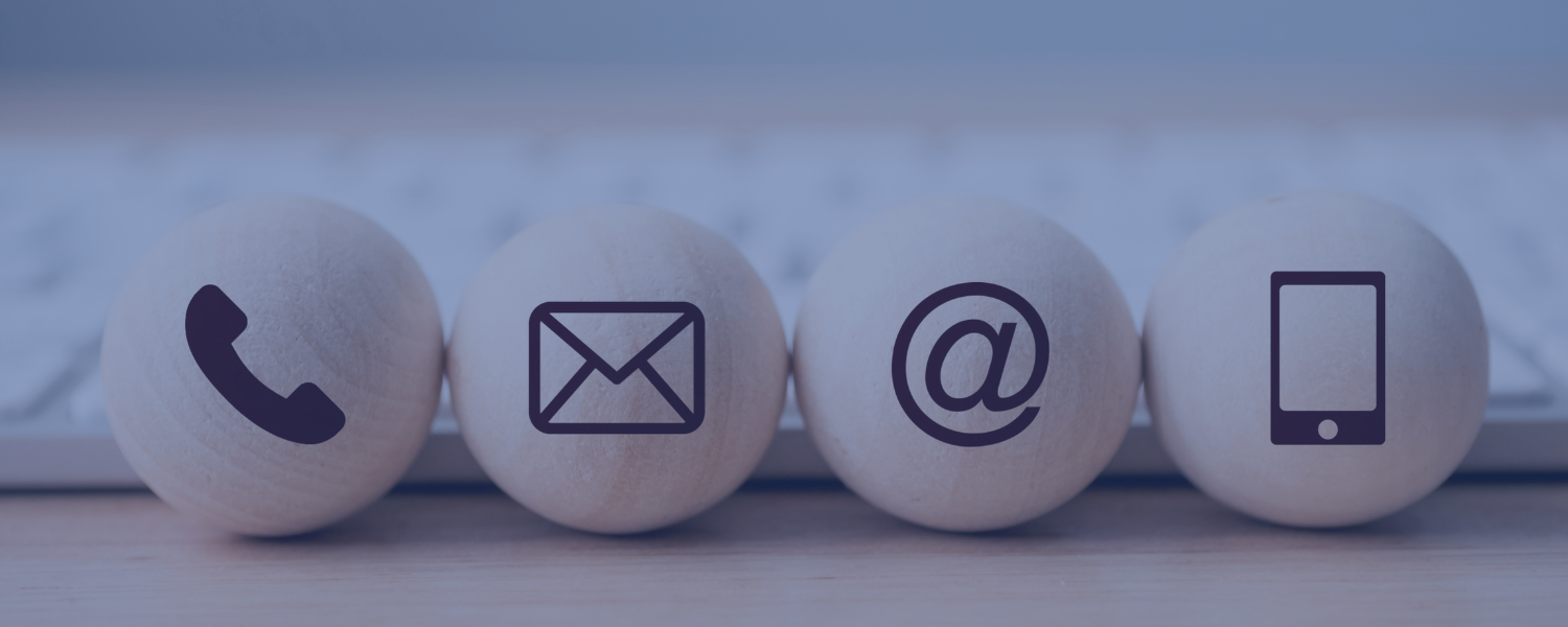 Four round balls with printed icons on them representing different communication methods